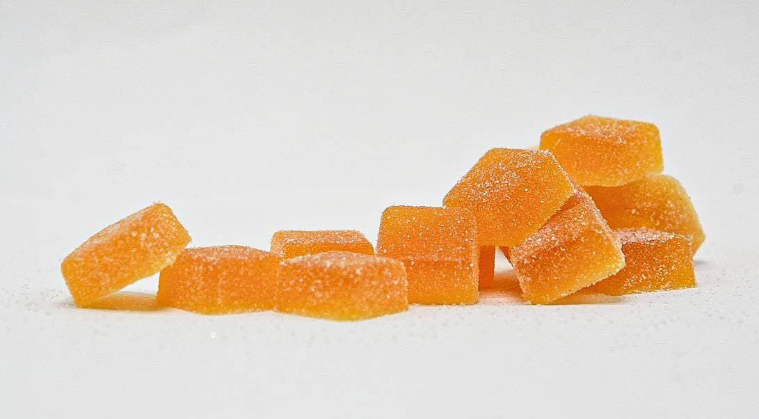 Tangerine Dream Gummies in hand